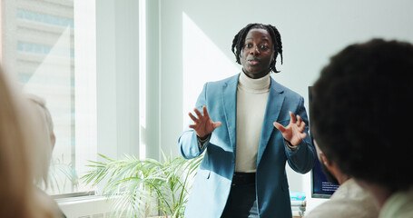 Man, speech and meeting for workshop with office, support and employee engagement. Male person, seminar and presentation with speaker, training and briefing for advice, learning and brainstorming