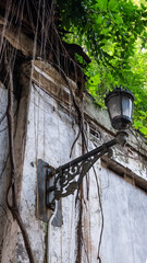 Vintage street lamp among historic old buildings, photographed from below