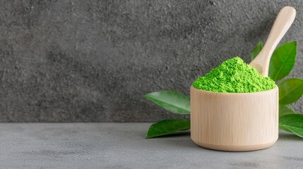 Green Powder in Wooden Bowl with Spoon and Green Leaves