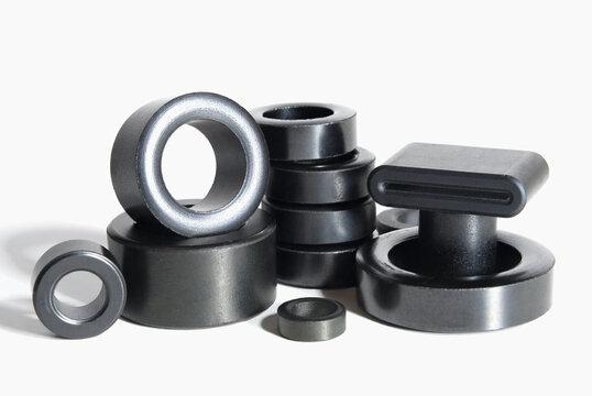 ferrite rings of various shapes and diameters on a white background
