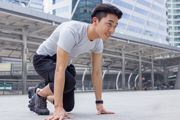 Sport Healthy Asian young man ready for go running at city outdoor office building background