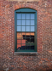 Arched Green Window In Red Brick Wall