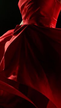 Brunette Woman in Ruby Red Dress Posing Against a Black Background . Filmed on High Speed Cinematic Camera in Super Slow Motion