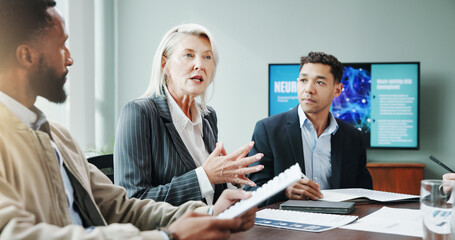 Meeting, business and people explaining in office for planning, neuroscience and innovation ideas. Manager, presentation and briefing with paperwork, brain technology and proposal with neurofeedback