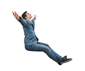 Excited young businessman seated with arms wide opened, looking up imagining himself in other place. Male isolated on transparent background dreaming of vacation