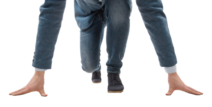 Determined young businessman kneeling at a start line isolated on transparent background. Business challenge and motivation concept