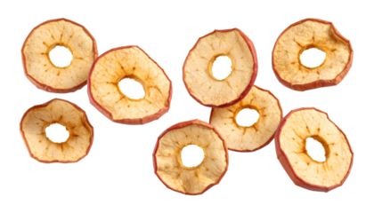 Multiple dried apple rings levitating on transparent background