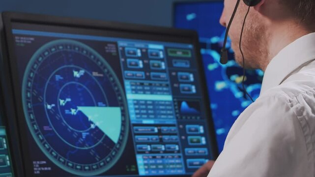 Professional air traffic controller in the control tower. Aircraft control officer works using radar, computer navigation and digital maps. Close-up portrait.
