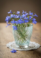 Blue Flowers in Glass Vase on Wooden Table