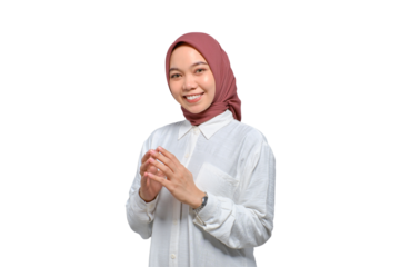 Portrait of smiling young Asian Muslim woman holding hands together and feeling confident isolated on transparent background