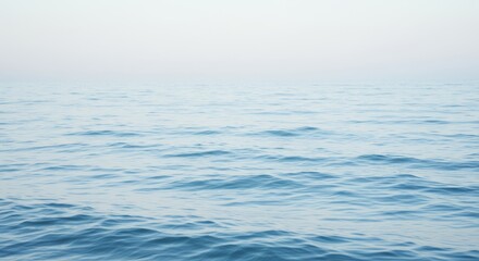 Serene Ocean Panorama: Gentle Waves and Soft Light - Calm ocean scene, symbolizing peace, tranquility, serenity, vastness, and freedom. A soft, light blue hue dominates