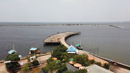 A bridge over the coast under a summer sky with boats on the water