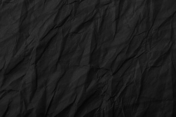 Abstract wrinkled black crumpled paper texture background