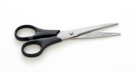 Fototapeta premium Open scissors with black handles and silver blades laying on a white background. Studio lit, sharp, simple and basic office or craft tool.