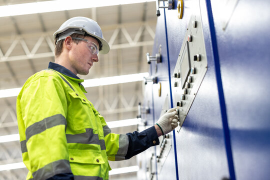 Team of engineer paper cardbox container factory in professional uniform check and analyse in paper industrial. Male factory worker testing program in high teachnology paper production line. worker.