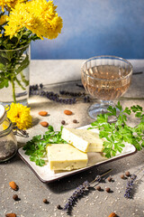 Gourmet cheese appetizer with herbs and wine pairing on a table setting