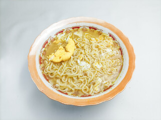 instant noodles with soto flavor with boiled egg. isolated on white background