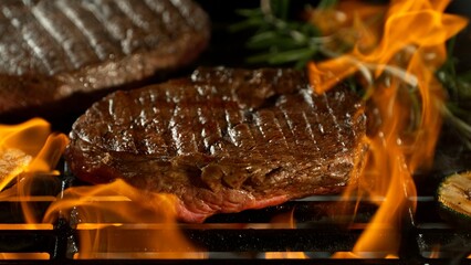 Close-up of Beef Steak on a Grill with Roaring Flames