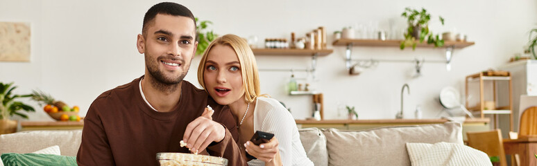 Couple sharing a cozy evening at home filled with laughter and love over snacks