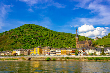 Lorch (Germany) with St. Bonifatius Church and Clemenskapelle above colorful riverside houses on a sunny spring day