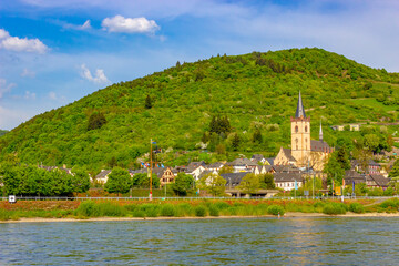 Lorch (Germany) with St. Martin Church surrounded by lush greenery and timber-framed houses on the Rhine