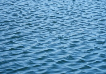 Fototapeta premium A serene view of gentle water ripples creating a calming and peaceful ocean surface texture scene