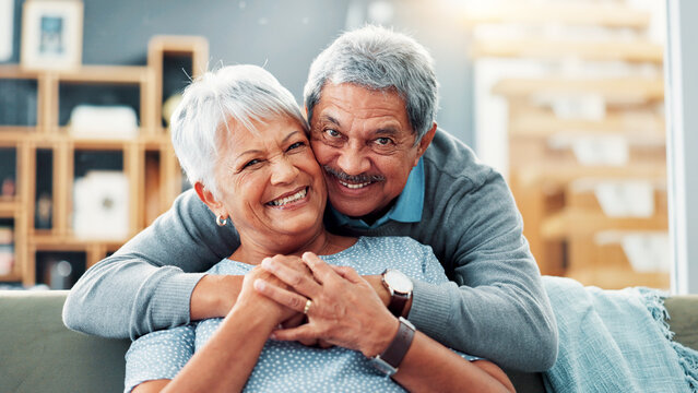 Portrait, hug and old couple with love, home and bonding together with smile in living room. Face, apartment and senior man with elderly woman, embrace and retirement with relationship and marriage