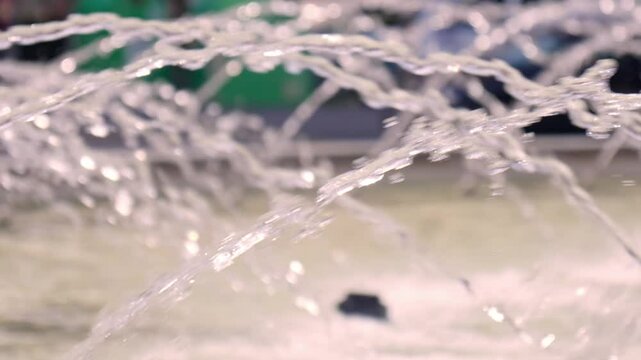Beneath the bright sun, droplets of water leap from a fountain, glistening like diamonds. Children play nearby, laughing and splashing each other, soaking up the joyful atmosphere.