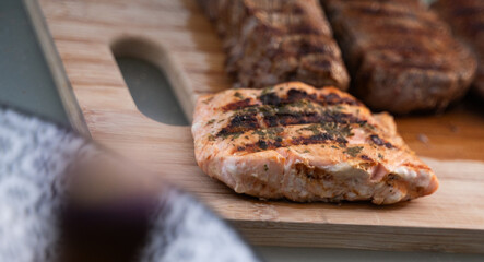 A Delicious Grilled Salmon and Meat Platter Displayed Beautifully on a Wooden Cutting Board