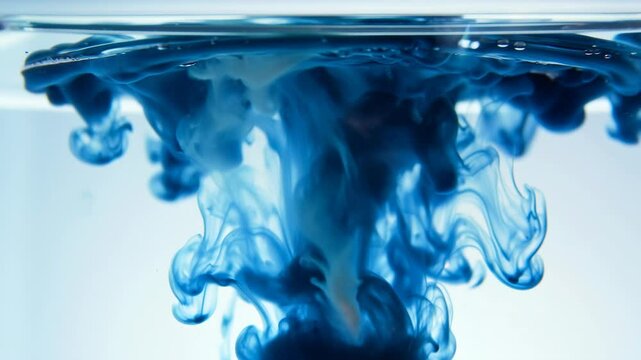 Blue ink swirling in water creating artistic patterns in triptych format