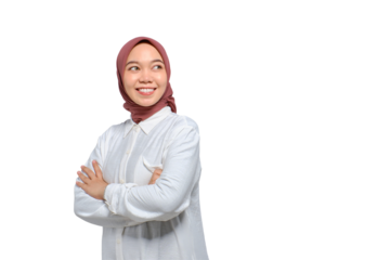 Smiling young Asian Muslim woman with arms crossed and looking away to copy space isolated on transparent background