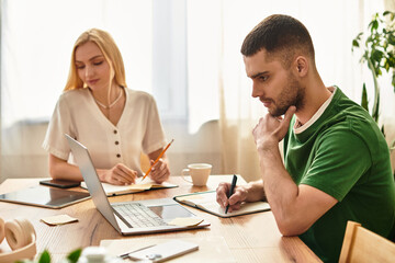 Fototapeta premium Couple enjoying quiet moments together while working at home during a sunny afternoon
