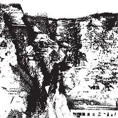 Obraz premium A lone figure stands silhouetted against a dramatic layered rock formation.