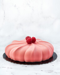 Elegant raspberry and white chocolate mousse cake with velvet texture and fresh raspberries. Side view on white marble with copy space. Perfect for branding, packaging or editorial use.