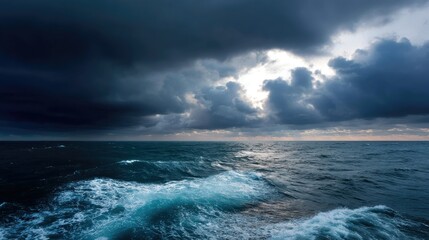 Fototapeta premium A view of the sea and sky on a stormy day, with dark clouds hovering above the turbulent ocean on the distant horizon
