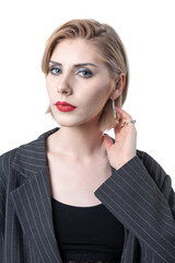 Portrait of a seductive, stylish business lady in the studio. Blonde girl in a suit and top.