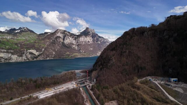 Switzerland freshwater river Linth reversing in natural water basin, aerial drone