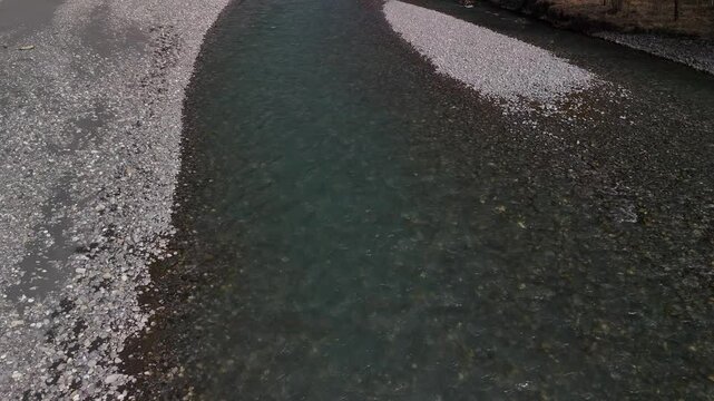 Linth river Switzerland slow aerial above creek stream pebble stones riverbank