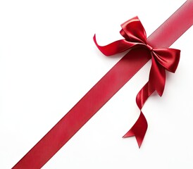 Red ribbon bow on white background.  A diagonally placed, wide red ribbon with a decorative bow.  High-quality image