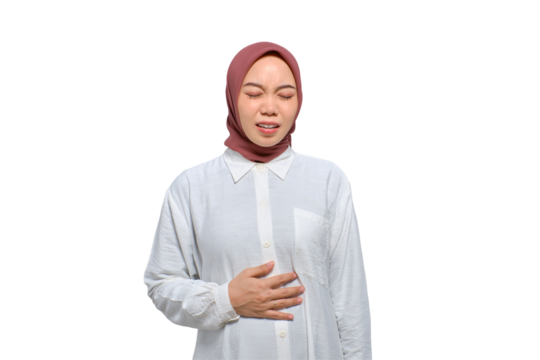 Unhealthy young Asian Muslim woman touching belly, having stomach pain isolated on transparent background