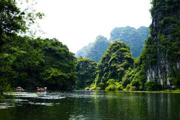 Fototapeta premium Ninh Binh, Vietnam - July 18, 2022 : Beautiful Natural Landscape In Trang An Landscape Complex Of Ninh Binh Province, Vietnam. Trang An Area Was Designated As A Dual UNESCO World Heritage Site.