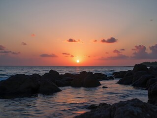 Obraz premium a sunset over a body of water with rocks and water