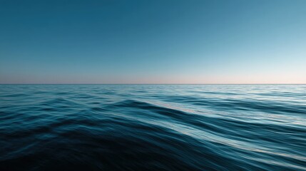 Obraz premium Wide open ocean with the horizon gently curving into the distance, under a soft, light blue sky