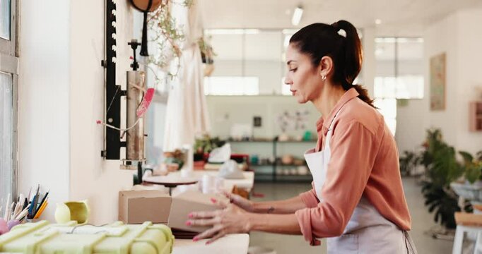 Business, packaging and woman in studio, boxes and delivery service with series. Mature person, supply chain or entrepreneur in workshop, prepare order for shipping, art product and distribution