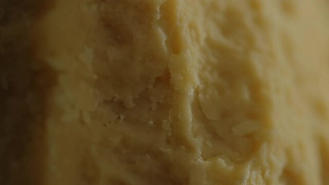 Many pieces of different types of craft cheeses close-up, assortment of cheeses with noble mold, parmesan, maasdam, camembert, stilton. Cheese textures and delicacies close-up, cheese manufactory.