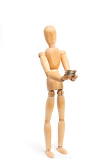 A wooden mannequin toy holding a heap of coins on his hands on white background