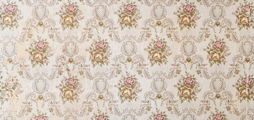 Old wallpaper on the wall. Old wallpaper for texture or background.