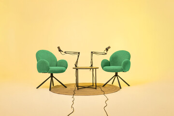 Podcast setup featuring two chairs and microphones in a vibrant educational space for interviews