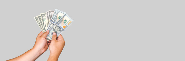 Banner, American money in the hands of a man on a white-gray background.