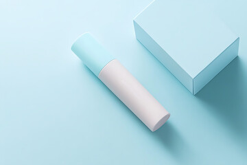 Minimalist product display featuring a cylindrical container and a square box on a soft blue backdrop